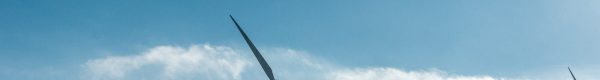 wind turbines on snowy mountain under clear blue sky during daytime