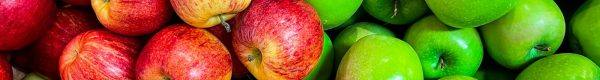 green and red apples on white plastic container