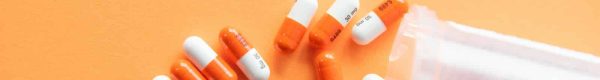 orange and white medication pill